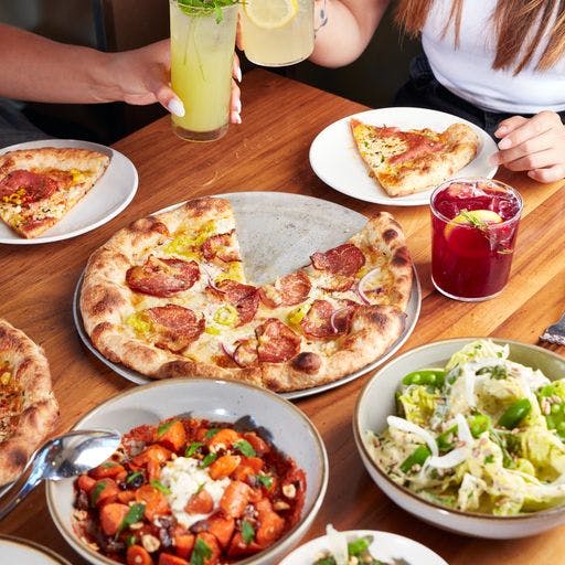 a pizza sitting on top of a wooden table